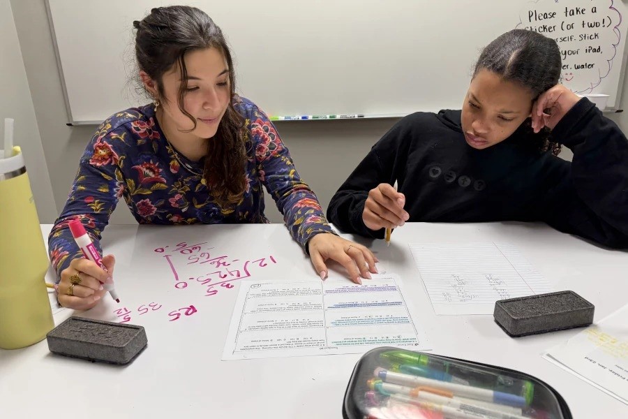 Math tutor helping a student solve problems during a tutoring session