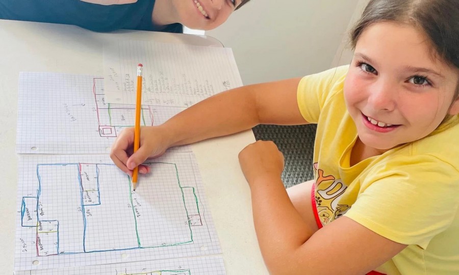 Student drawing math diagrams on graph paper during a tutoring session